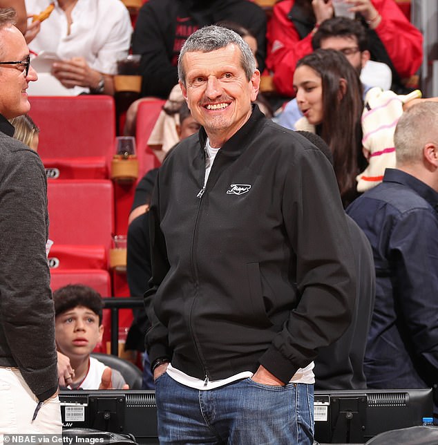 Former Haas boss Steiner smiles while sitting on the field in his black sweater from the Miami GP