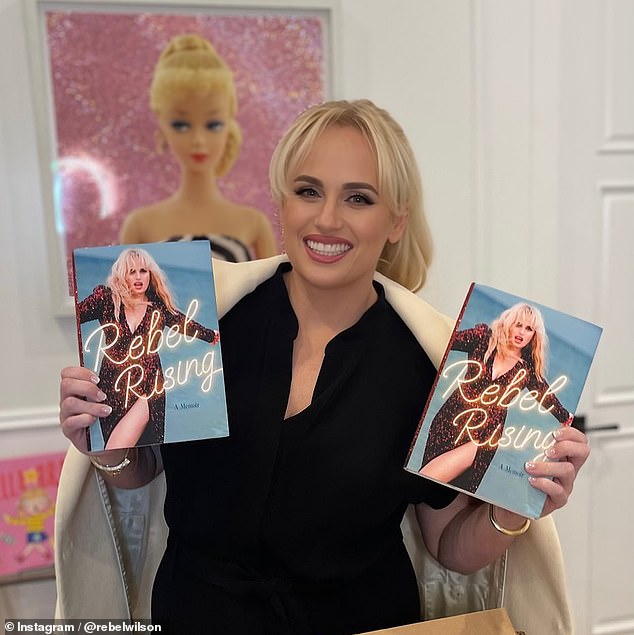 Rebel has now claimed she had an uncomfortable experience while filming the comedy ¿ claims which Sacha has said are false and contradicted by evidence - and shared details in a new excerpt from her autobiography (pictured with her book)