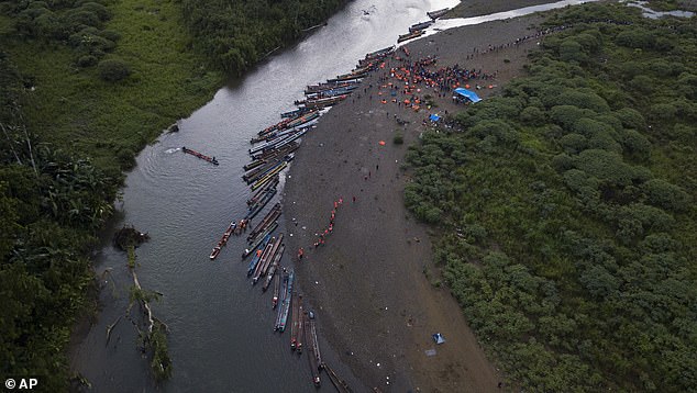 Migrants heading north take boats in Bajo Chiquito in Panama's Darién province in 2023