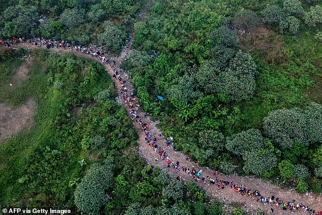 Aerial view showing migrants walking through the jungle near the village of Bajo Chiquito, the first border control in Panama's Darién province, on September 22, 2023.