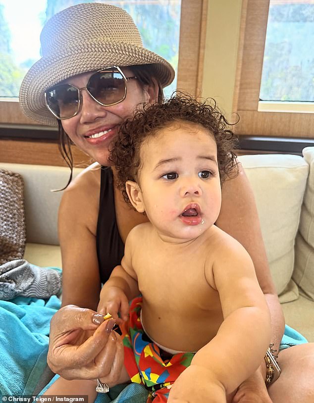 Chrissy shared a photo of her mother Vilailuck holding her grandson.