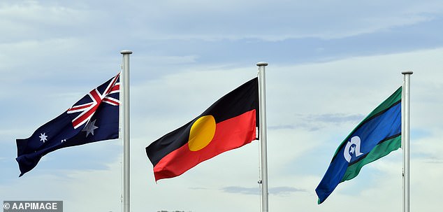 There are no official policies on singing the national anthem in South Australian schools (pictured are the Australian, Aboriginal and Torres Strait Islander flags).