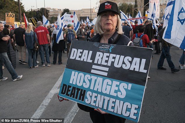 An unnamed official said national security adviser Jake Sullivan will meet on Monday with relatives of some of the hundreds of hostages still held in Gaza.  (A woman holds a sign calling for the return of hostages at an 'anti-Netanyahu protest' in Jerusalem - March 31, 2024)