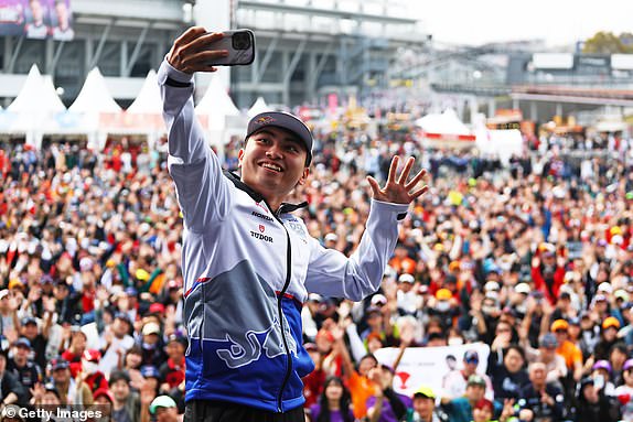 SUZUKA, JAPAN - APRIL 6: Ayumu Iwasa of Japan and Visa Cash App RB take a photo on the fan stage before qualifying ahead of the F1 Japanese Grand Prix at the Suzuka International Racing Course on April 6, 2024 in Suzuka, Japan. (Photo by Peter Fox/Getty Images)