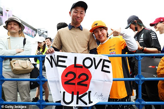 SUZUKA, JAPAN - APRIL 6: A fan of Japan's Yuki Tsunoda and Visa Cash App RB shows their support with a flag before qualifying ahead of the Japanese F1 Grand Prix at the Suzuka International Racing Course on April 6, 2024 in Suzuka, Japan. (Photo by Peter Fox/Getty Images)
