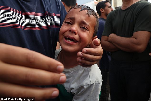 A Palestinian child cries as victims of an Israeli bombing raid arrive at al-Najjar hospital in Rafah, southern Gaza Strip, April 1, 2024.