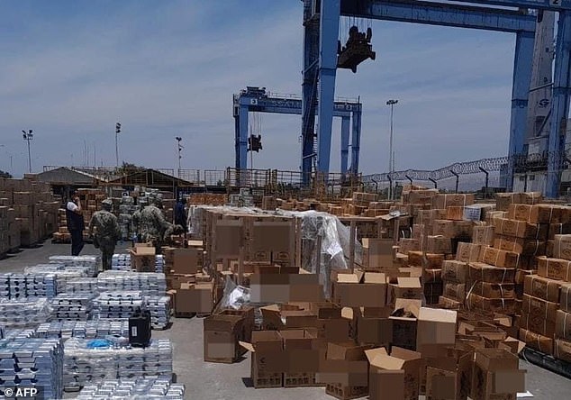 The Mexican Navy shows boxes of liquid methamphetamine hidden in tequila bottles seized in the port of Manzanillo