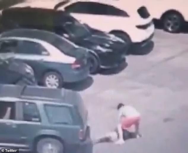 The woman was hit while lying on the ground during the altercation in the mall parking lot.