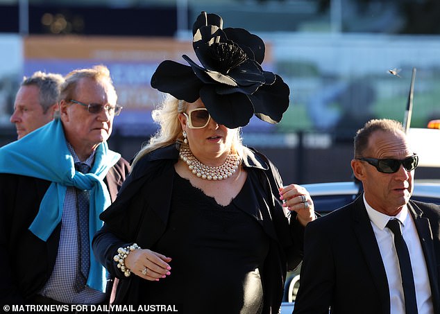 This woman went the extra mile and wore a black hat, as well as a black dress and white jewelry.