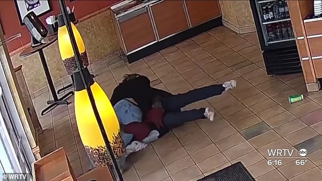 The incredible moment was captured on the store's surveillance camera, showing the brave former high school wrestler charging at the attacker and successfully taking him down.