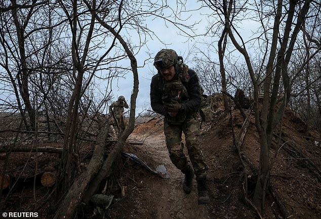 Servicemen of the 12th Azov Special Forces Brigade of the Ukrainian National Guard run to their positions on the front line. Ukraine has claimed that there have been 626 gas-related attacks by Russia since the outbreak of the war.