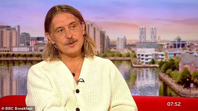 Same but different: Mark Owen looked a far cry from his early Take That days when he appeared on BBC Breakfast on Monday with long hair and a moustache.