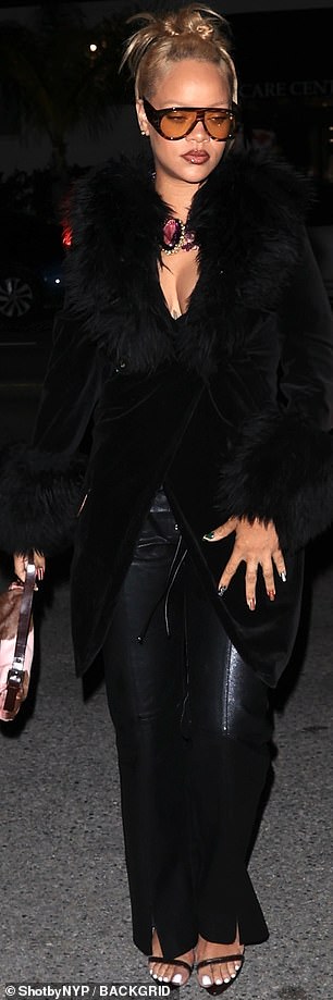 For the occasion, she made a splash in a pair of black leather pants and a long black coat that featured luxurious fur trim.
