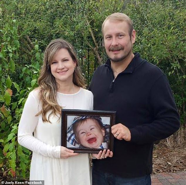 The couple pictured with a photo of their son who died in 2012 when he was just two years old.