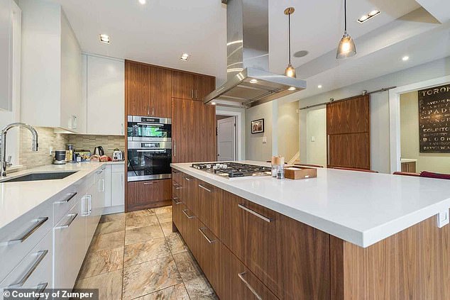 A city report clarified that the home's preservation designation was due to its architectural significance, not its ownership history (pictured: the home's newly renovated kitchen).