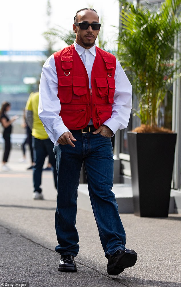 The Formula One driver, 39, donned a smart red military-style vest as he made his entrance before the big race.