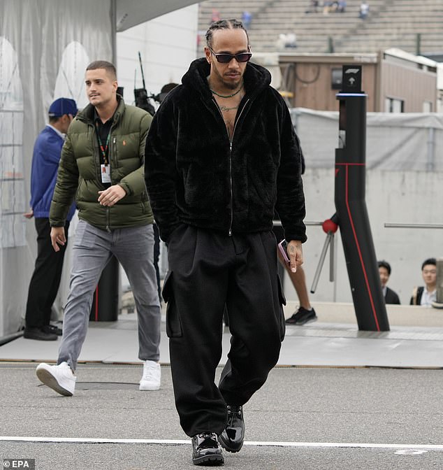 The Formula One driver, 39, showed off his chest tattoos as he donned a black fur hoodie and matching cargo pants to practice.