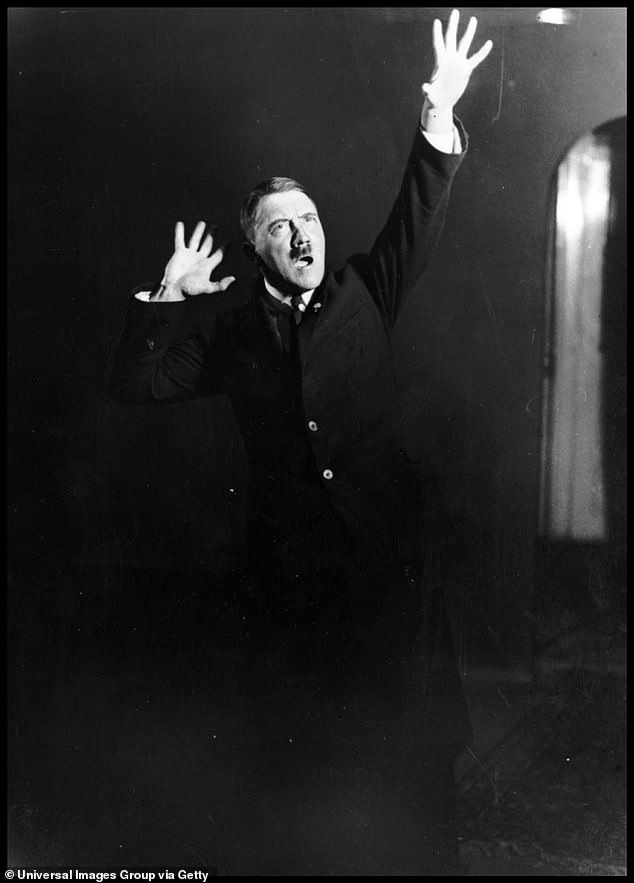 Hitler pictured rehearsing a speech in front of the mirror in 1933.