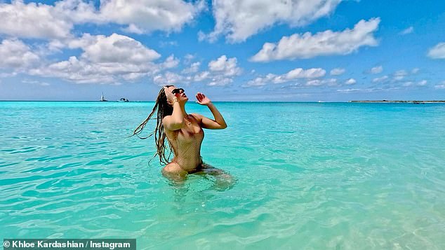 The Good American founder, 39, channeled her inner mermaid in a skimpy SKIMS swimsuit while frolicking in the ocean.