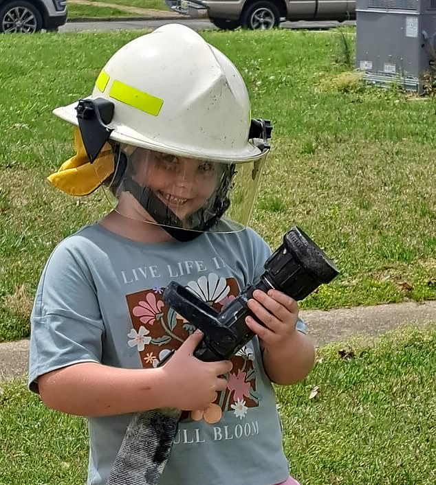While serving city residents, he posed for photos with firefighters, who even let him try out the hose and wear one of their helmets.
