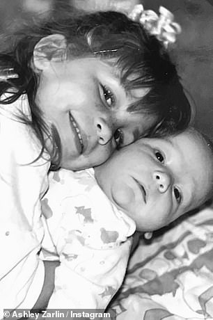 Ashley shared photos with her brother when she was a newborn. Her loving older sister smiled as she welcomed her little brother.