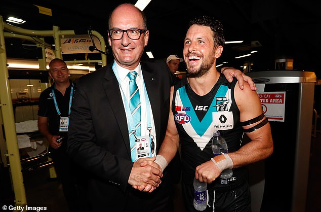 Koch (pictured with Travis Boak after a match in 2017) said Finlayson should be treated the same as Alastair Clarkson, who was not forced to miss a match after allegedly using a homophobic slur against two St Kilda players in the preseason.