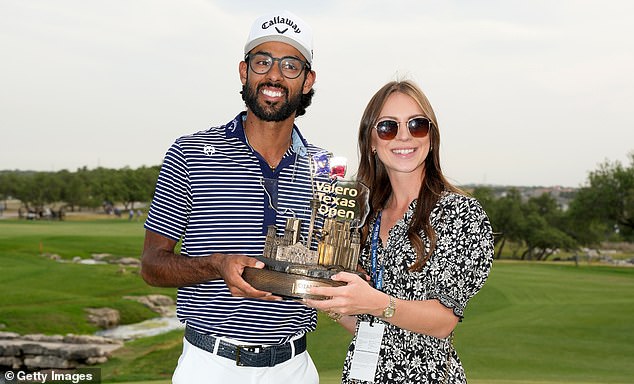 Bhatia poses with the Valero Texas Open trophy with his fiancee Presleigh Schultz