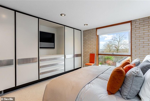 The house has four bedrooms, including this one with a panoramic view from the large window