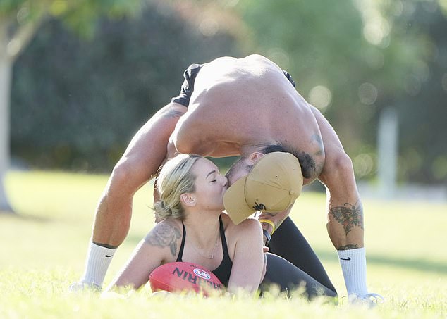 The couple shared a passionate kiss between ball games.