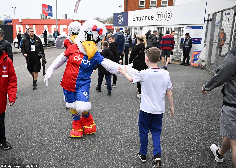 A fan high-fived Palace mascot Alice the Eagle before entering the famous stadium.