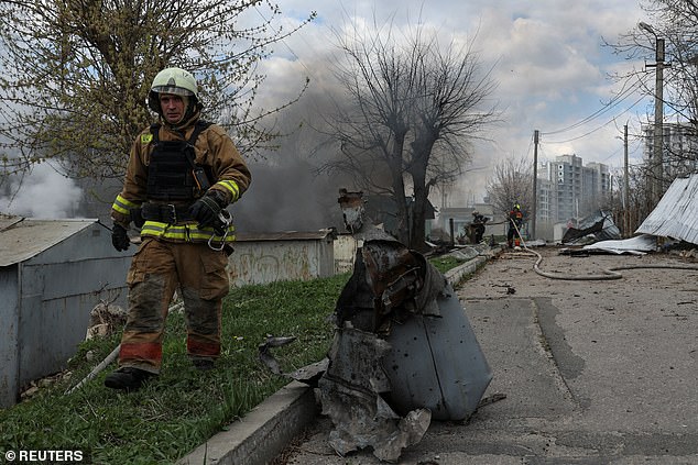 Firefighters work at the site of a Russian airstrike, amid Russia's attack on Ukraine on Sunday.