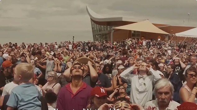 With the theme song 2001: A Space Odyssey playing in the background, the video then cuts to photos of crowds gathering to watch the eclipse with their glasses on.