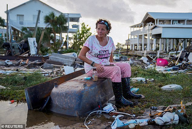 Jewell Baggett, 51, sits in a bathtub in the rubble of her home in Horseshoe Beach, Florida, which Hurricane Idalia reduced to rubble in August 2023.