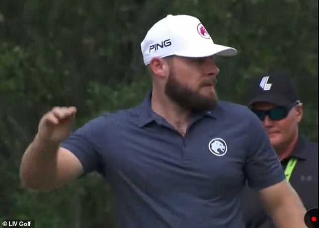 The Englishman throws his tee in disgust after his drive on the par-4 14th