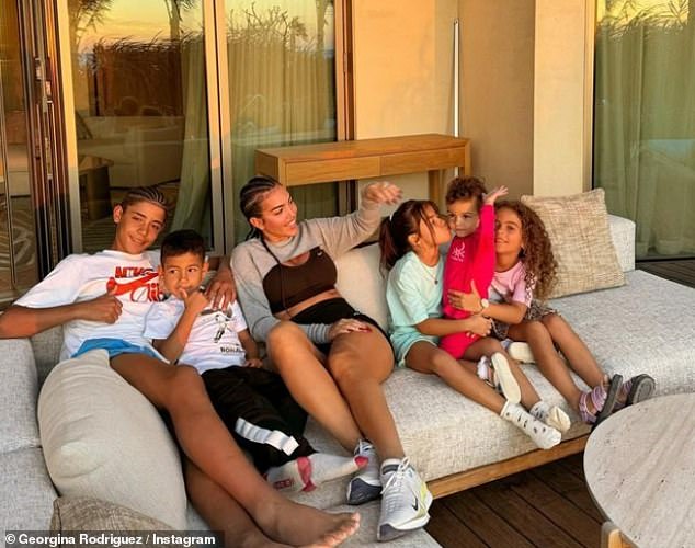 Sitting curled up on the sofa, Georgina was accompanied by her entire brood, including her daughters Alana, five, and Bella, 18 months, and Ronaldo's three other children, Cristiano Jr, 13, and twins Mateo and Eva , of six.