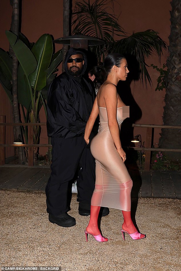 Kanye West's wife also showed off a side view of her racing ensemble that accentuated her shapely backside.