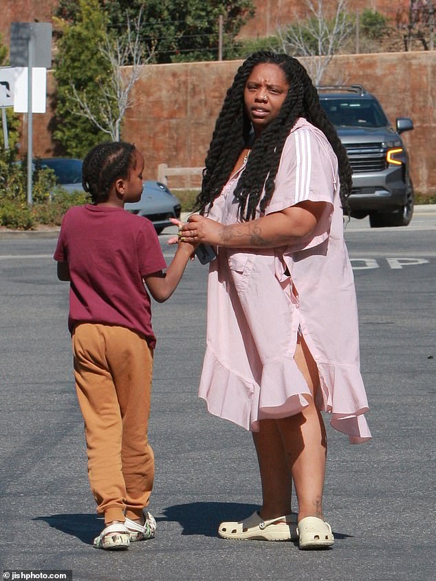 Cullors, who was accompanied by her son, was makeup-free and dressed in a shapeless pink poncho from Adidas and Crocs.