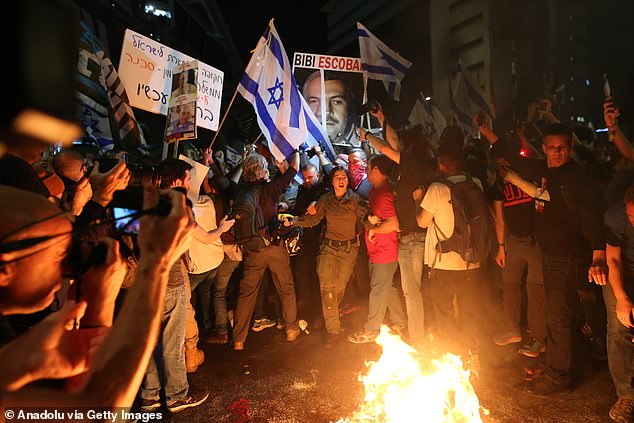 Protesters light a fire on Kaplan Street in Tel Aviv.