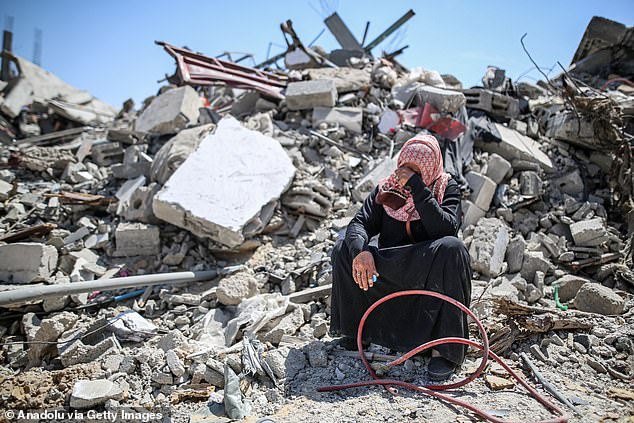 A woman cries in the rubble of a collapsed building after the withdrawal of Israeli forces from Khan Younis, Gaza.