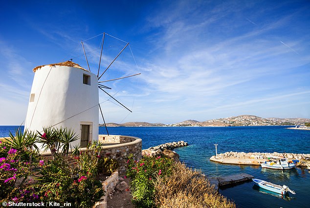 Charlie visits the town of Parika, home to a traditional windmill, pictured, overlooking the water