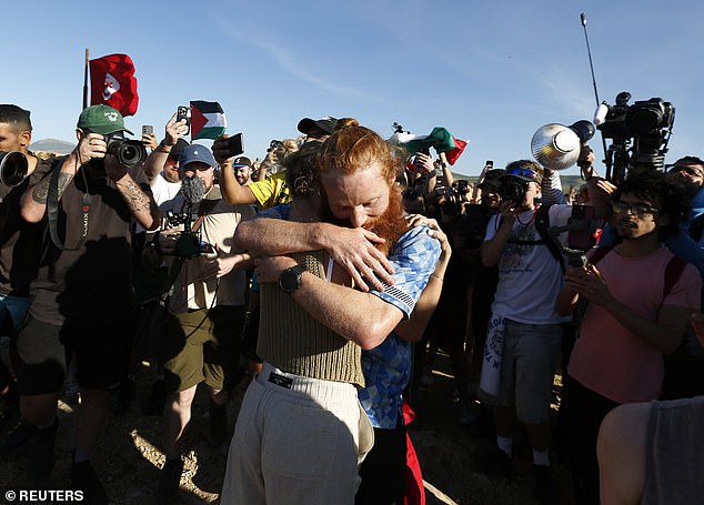 Cook hugs his fans at the finish line after completing 385 marathons in one year.