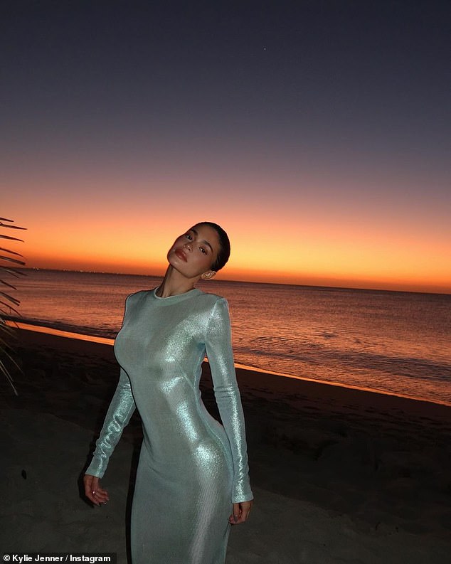 Kylie has been posting up a storm on her Instagram while on vacation, including a stunning photo of herself in a long-sleeved silver dress.