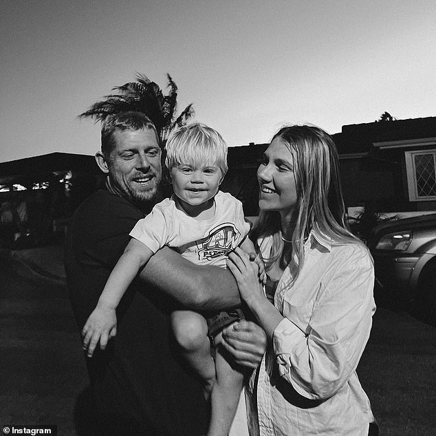The surfing icon is pictured with his fiancee Breeana Randall and their son Xander, who was born in August 2020.