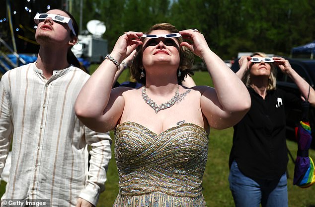 The event, titled 'Elope at the Eclipse', began at 1:30 pm and ended at 1:45 pm, just minutes before the moon covered the sun on Monday.  The eclipse lasted about four minutes.