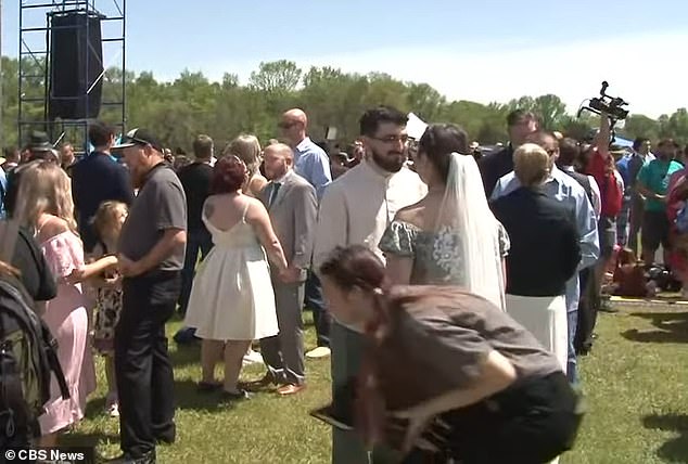 Brides and grooms from more than 24 states headed to Russellville, Arkansas, and gathered at the town's football complex to get married.