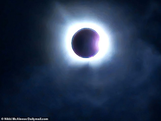 Millions of Americans took to the streets to watch the total solar eclipse.  Pictured: The solar eclipse seen in Dallas, Texas