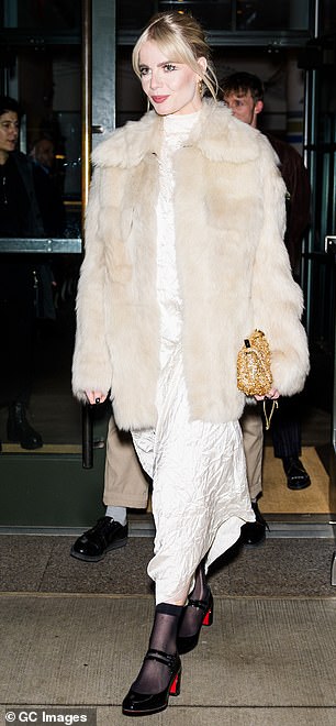 That night, she rocked yet another ensemble in a white, ankle-length crumpled satin dress with a mock turtleneck, paired with an off-white fur coat.