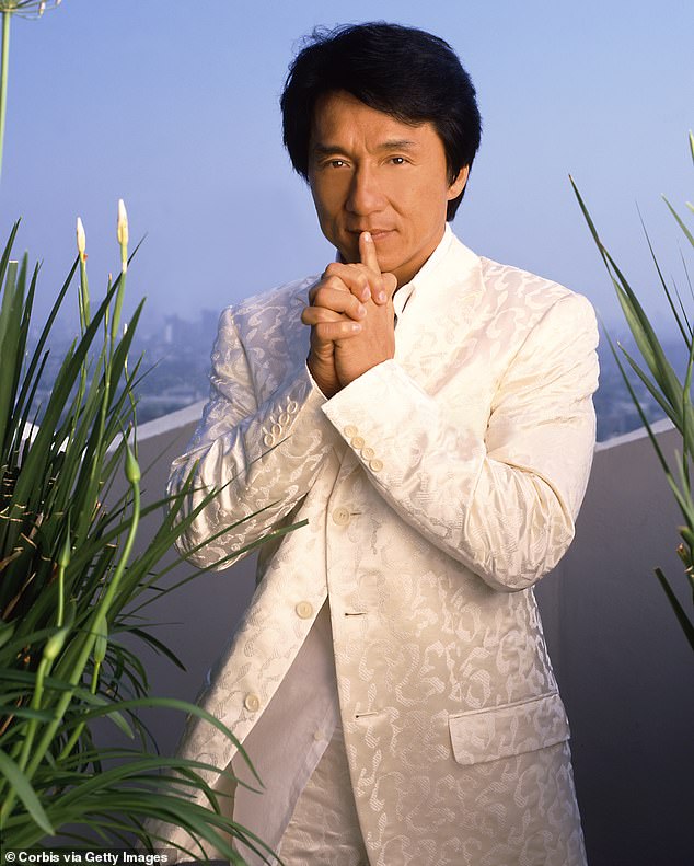 Another image was taken posing on a balcony in 1980 while sporting an all-white outfit with the city skyline directly behind him in the background.
