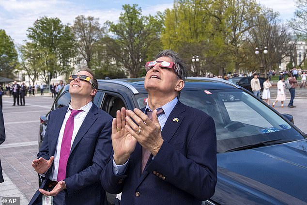 Senator Manchin applauded as the moon moved in front of the sun on Monday.