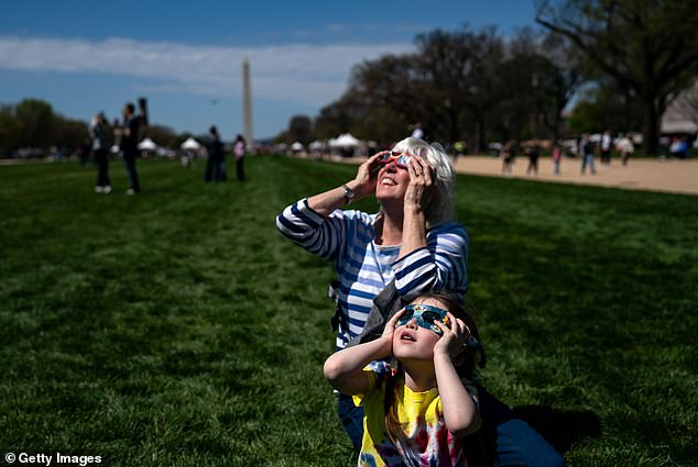 Americans also flocked to the nearby National Mall to witness the rare event.